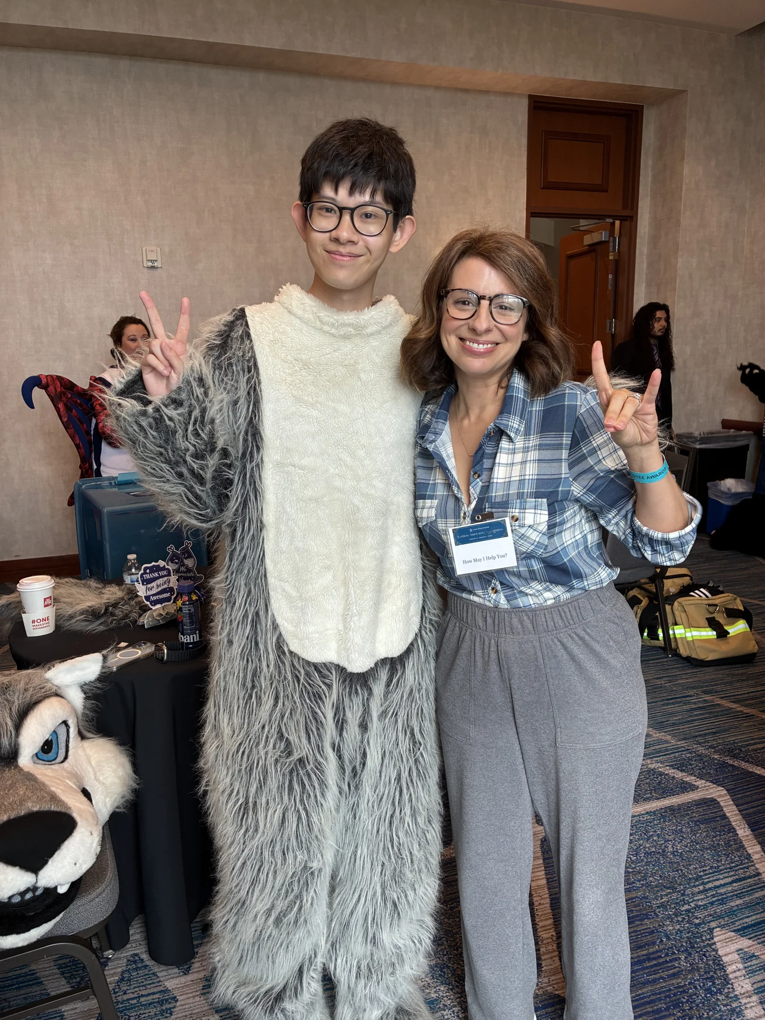 Dongfang in the Timberwolf costume with the head removed, posing beside an event participant