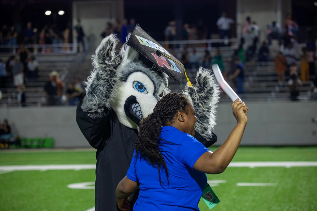 Timberwolf wearing a graduation cap at commencement