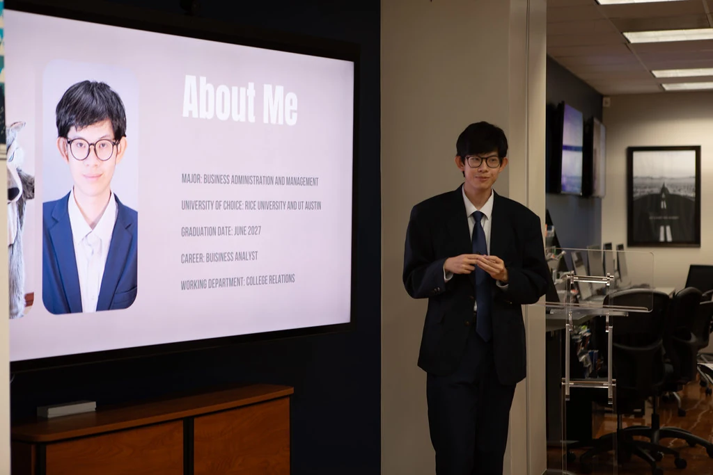 Dongfang in a suit speaking beside an About Me slide