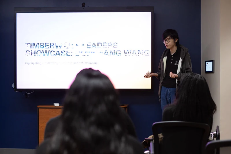 Dongfang addressing an audience at a campus presentation